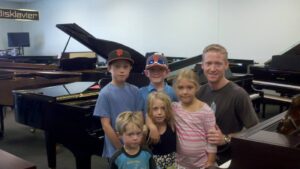 Briggs family and their new Yamaha Grand Piano