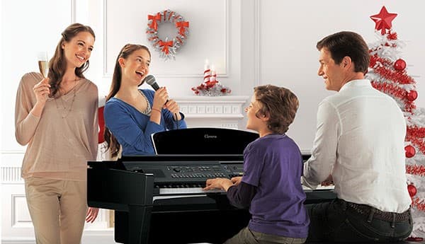 A family gathers around their digital calvinova, playing the keyboard and singing.