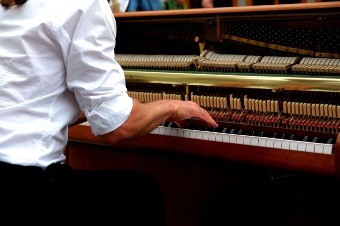 lady playing open piano