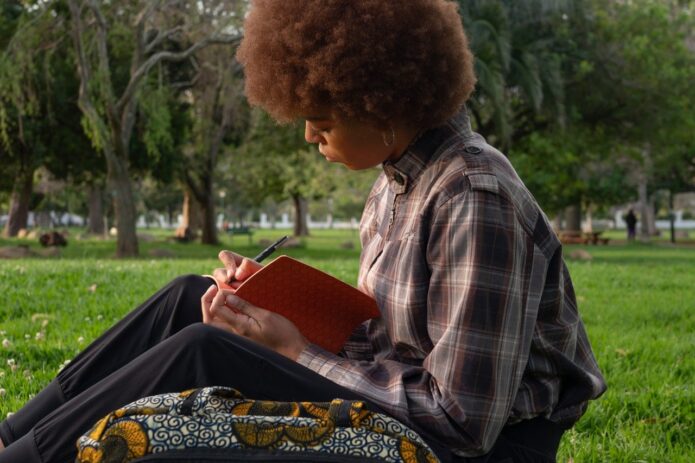 boy writing in book