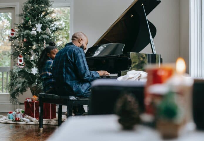 man and daughter at piano