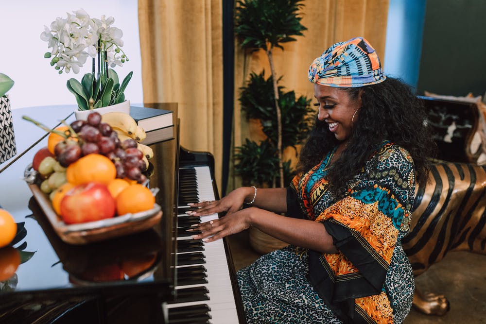 Lady smiling with piano playing fruits