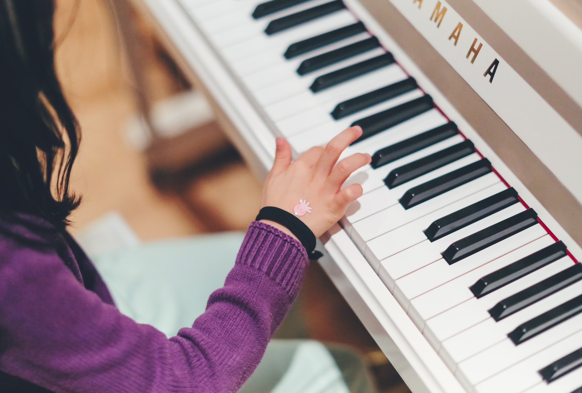 White piano girl playing keys