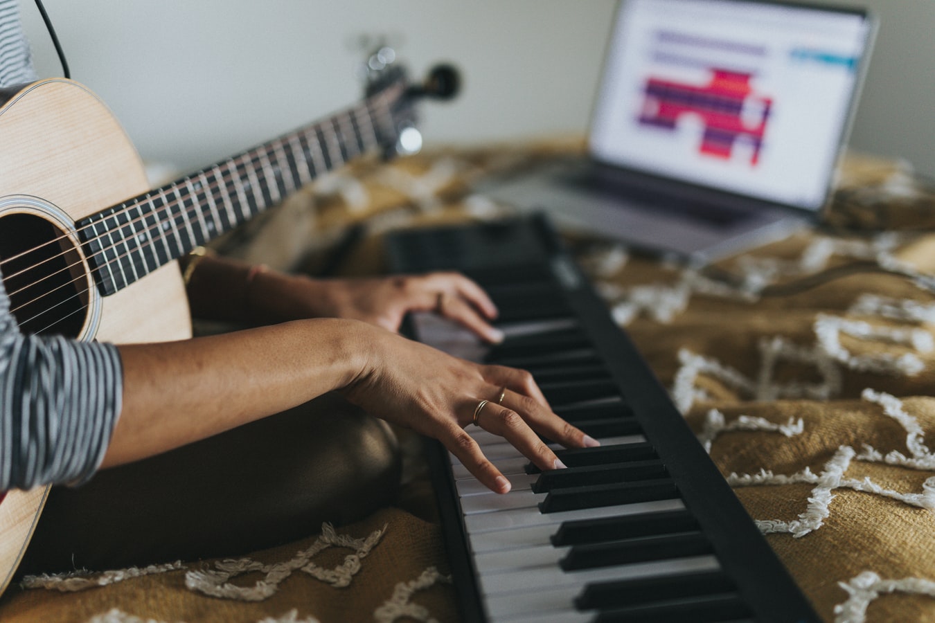 woman with keyboard and guitar at computer