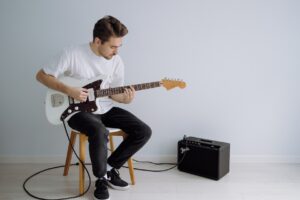 Man with electric guitar and amp