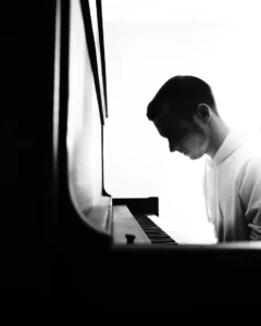 black and white man at piano