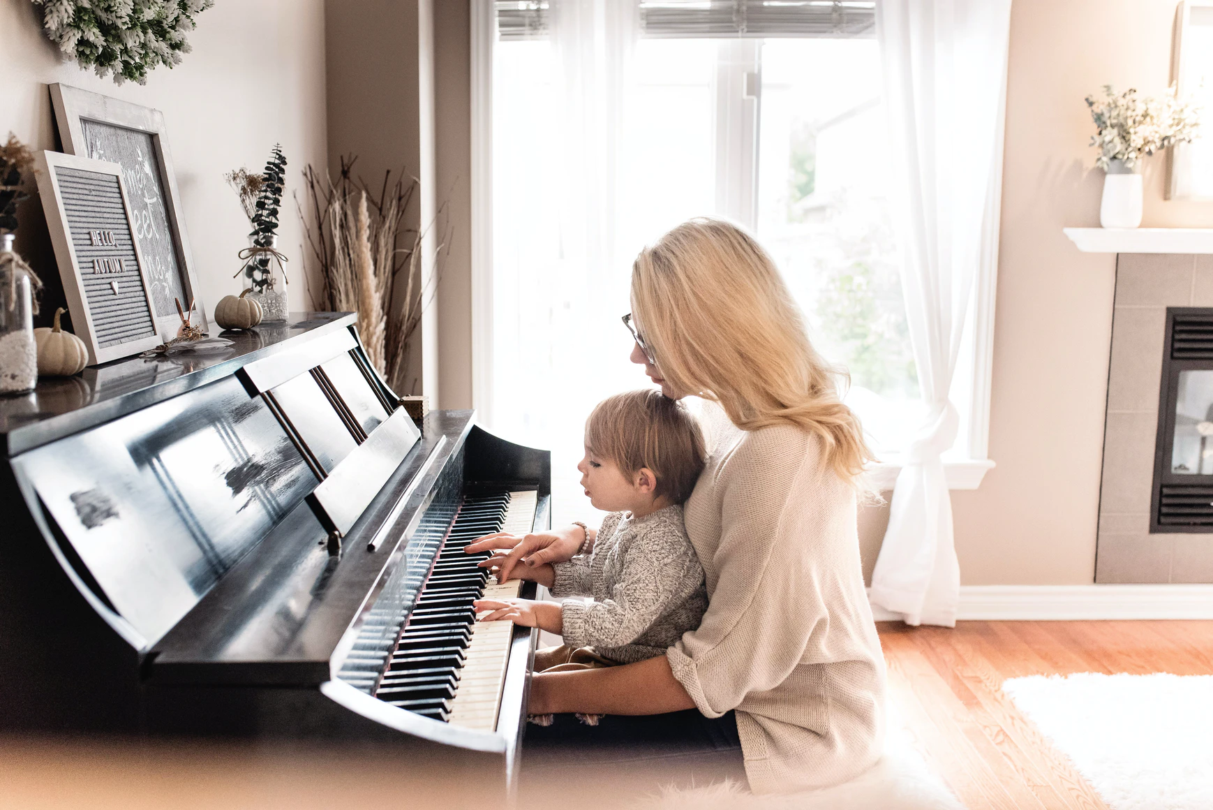 baby at piano with mother