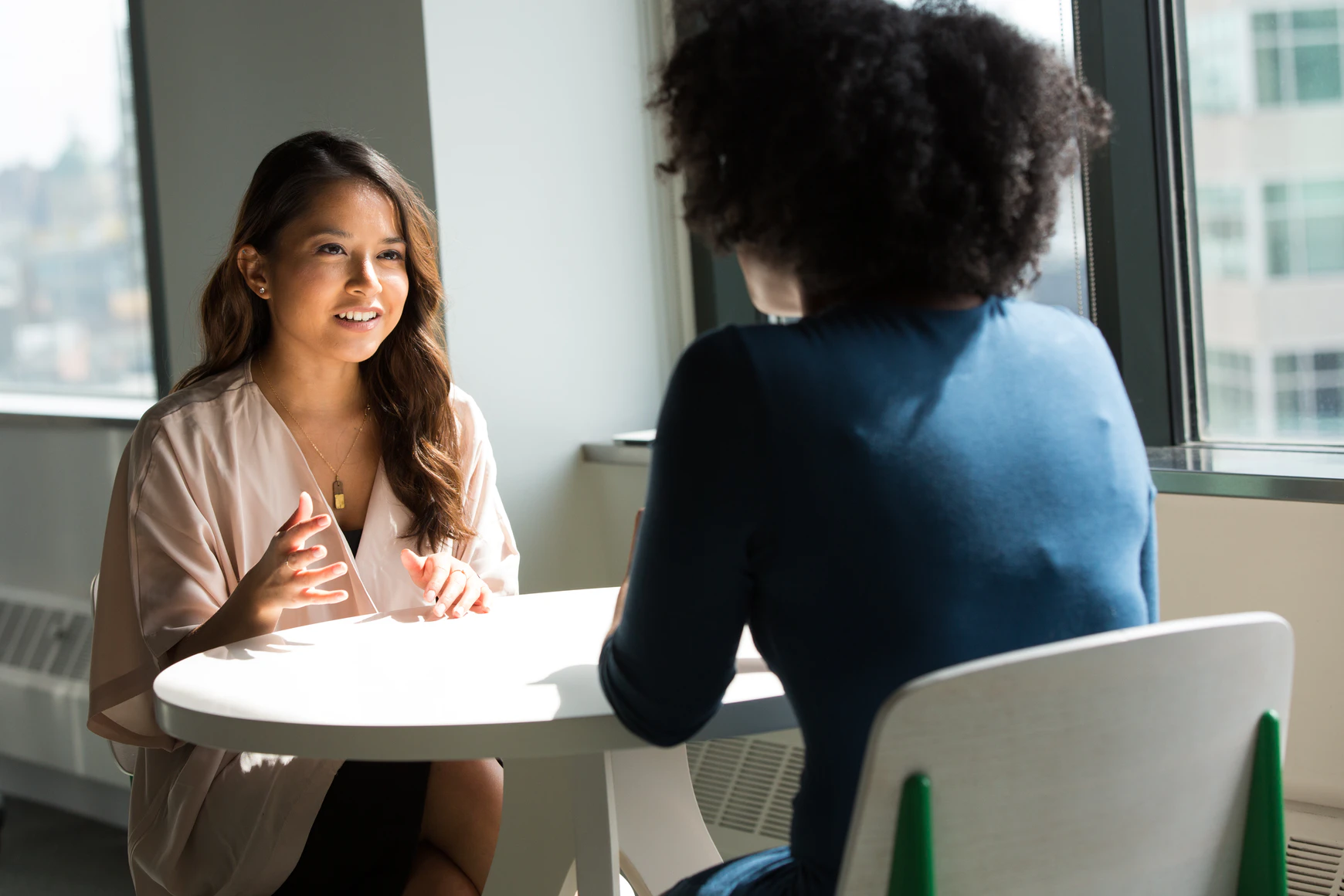 two ladies talking at a table