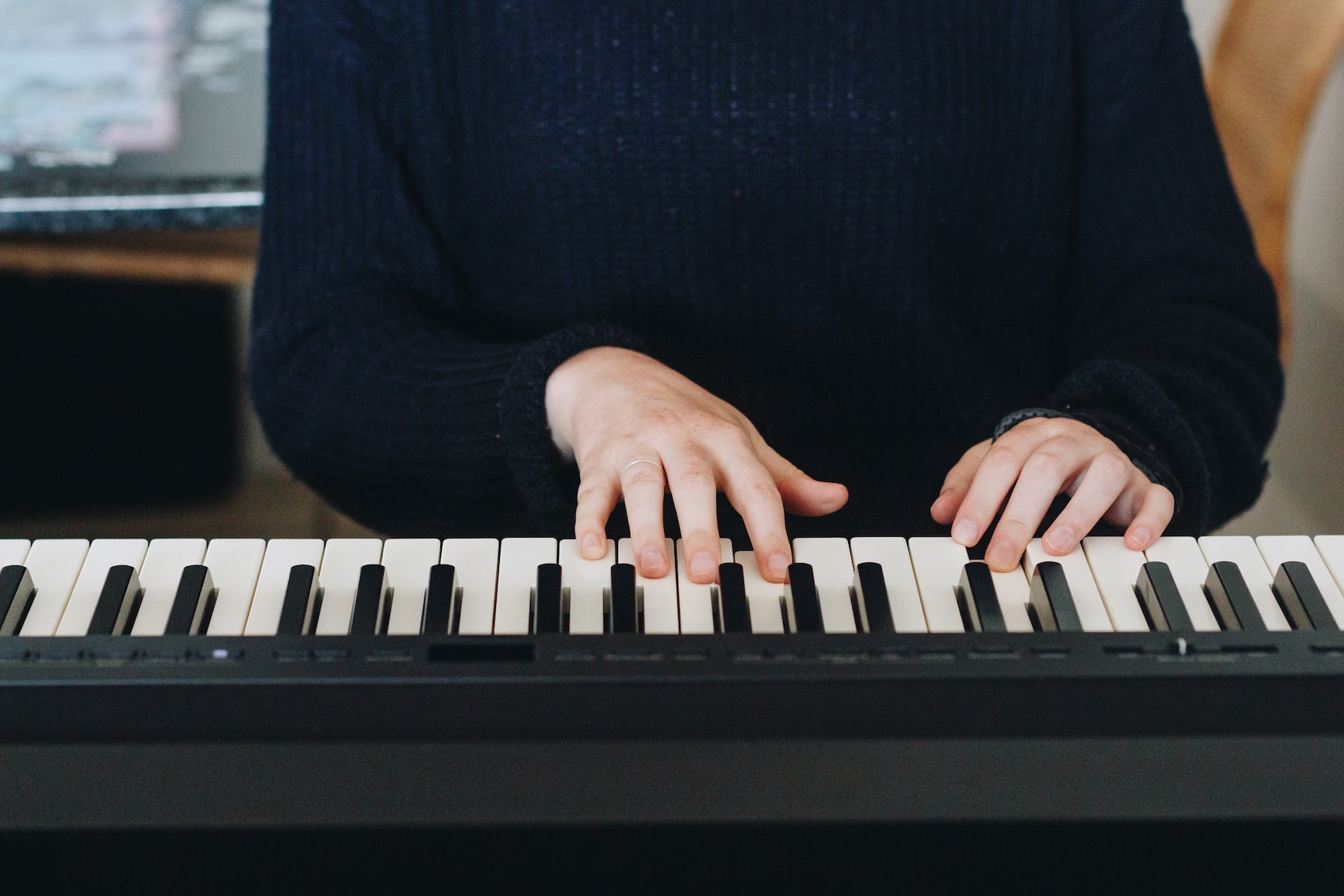 Hands on piano keyboard