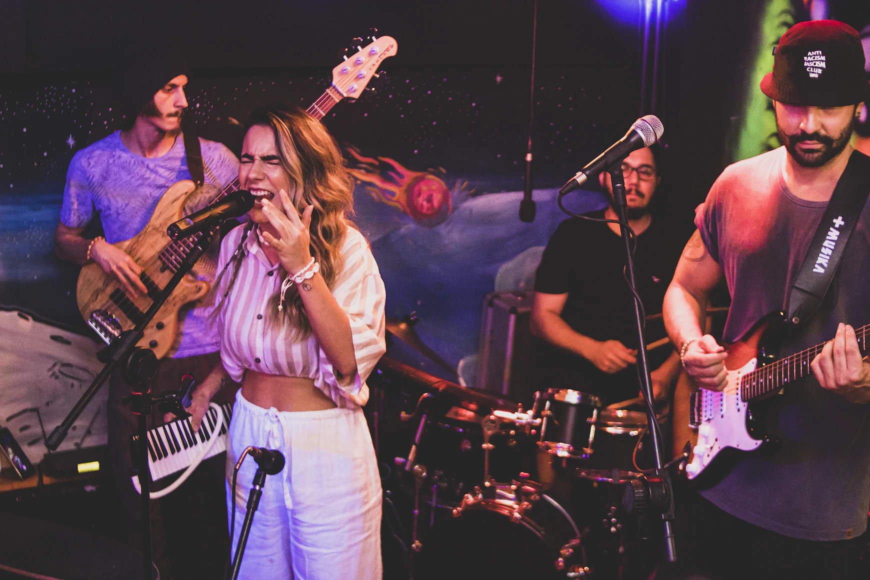 girl with band singing with eyes closed