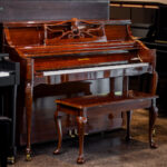 Used Charles R. Walter 1520 console piano in polished mahogany, Queen Anne style with cabriole legs, carved music desk, and matching bench on display at Miller Piano Specialists in Nashville, TN.
